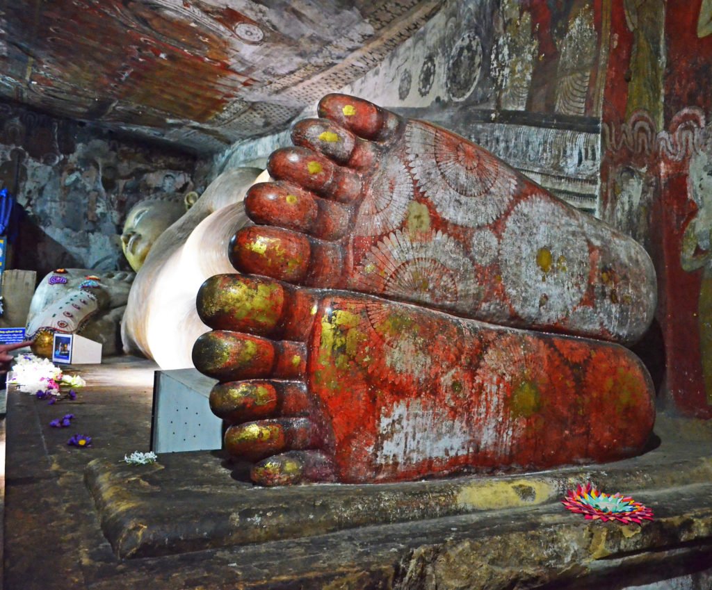 The giant lying down Buddha statue inside Dambulla Cave Temple